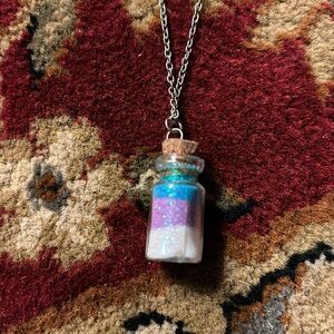 Teal, purple and white sparkly and in a bottle necklace silver color chain